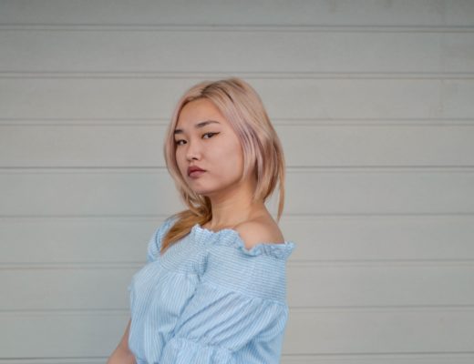 Junge Frau trägt hellblaues Off-Shoulder-Kleid im koreanischen Street Style – Beispiel für Korean Fashion.