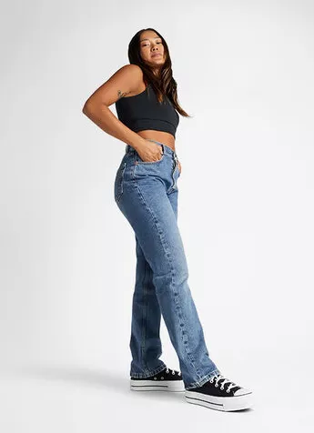 Frau in Jeans und Croptop mit schwarzen Converse Plateau – moderner Streetstyle-Look