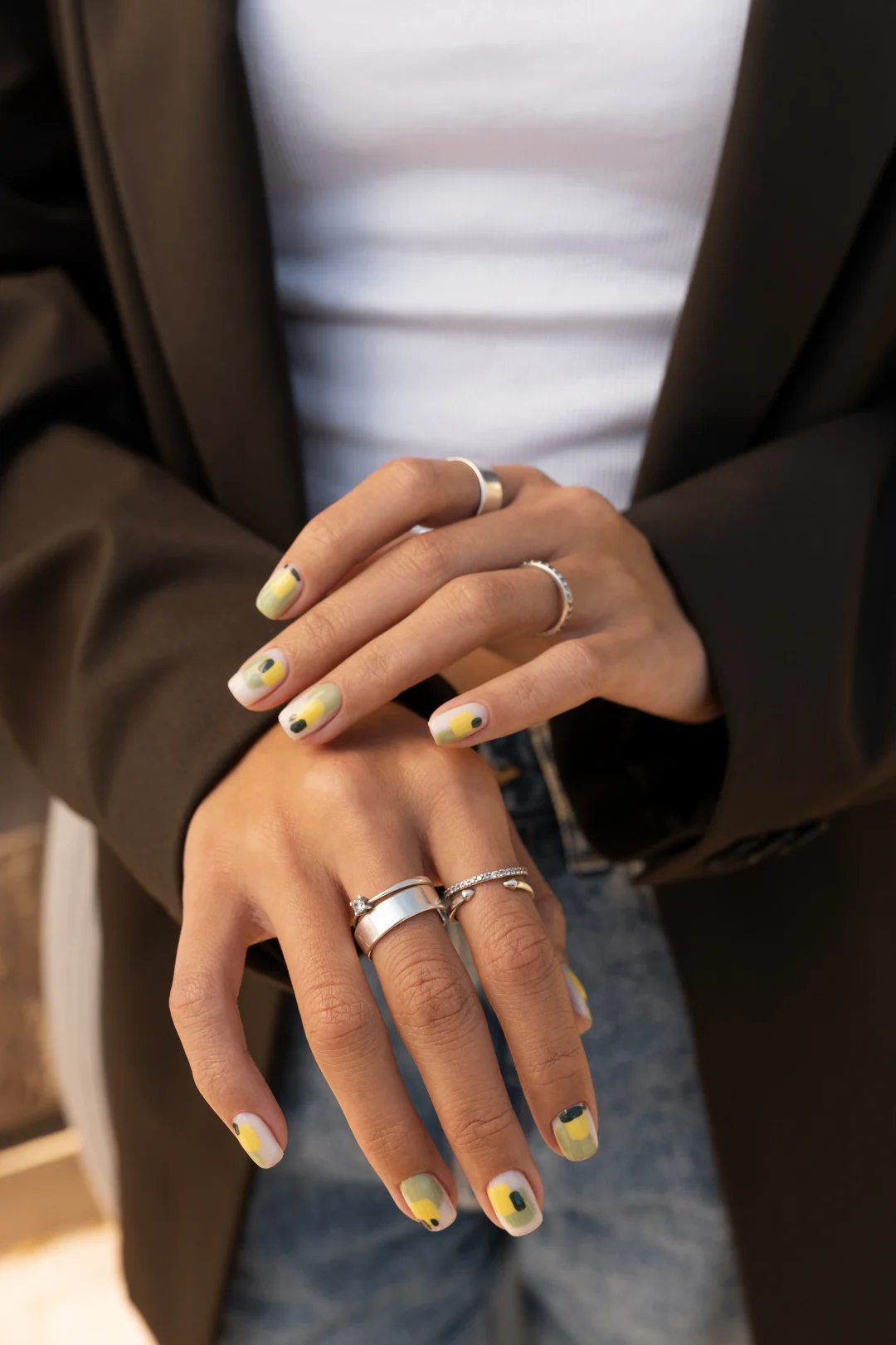 French Nails auf kurzen Nägeln: Nude-Basis mit geschwungener weißer Spitze, feinem Glitzer und dezenten Linien-Details.