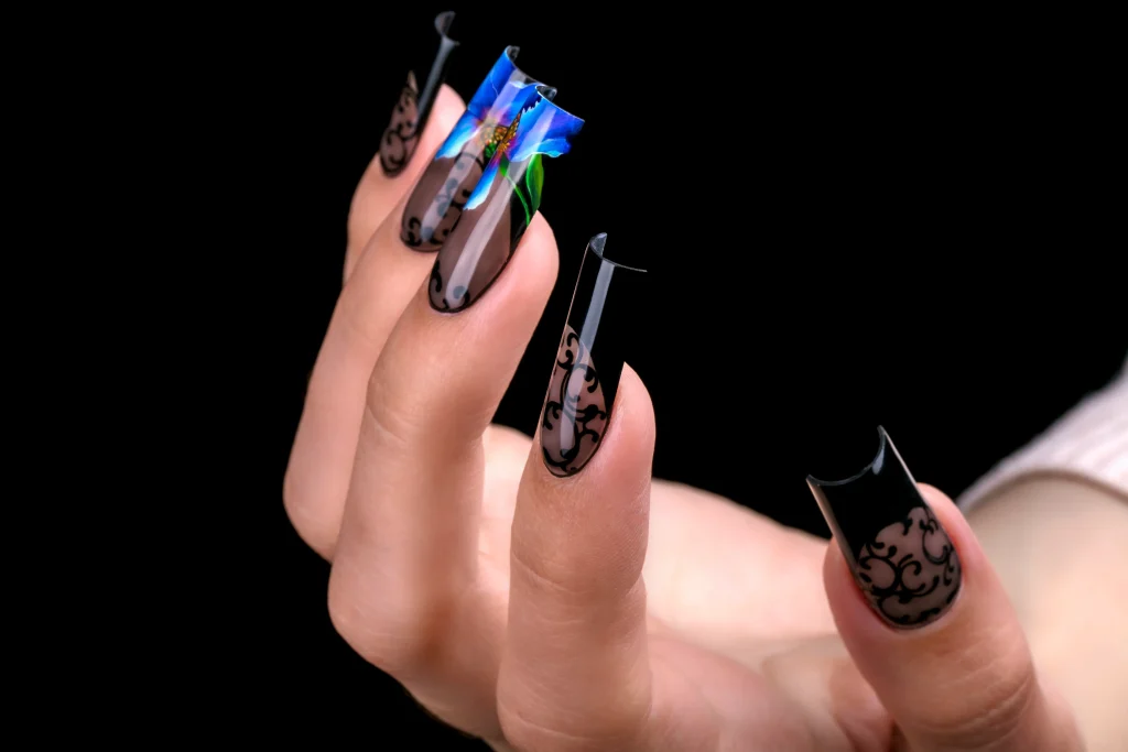 Frühlingsnägel 2026 mit extralangen Nägeln in Schwarz, transparente Nail Art mit grafischen Mustern und floralen Akzenten