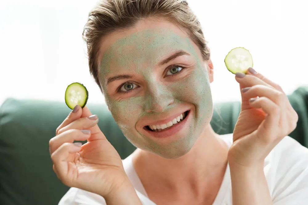 Frau mit grüner Gesichtsmaske und Gurkenscheiben als Teil einer modernen Micro-Beauty-Routine 2026