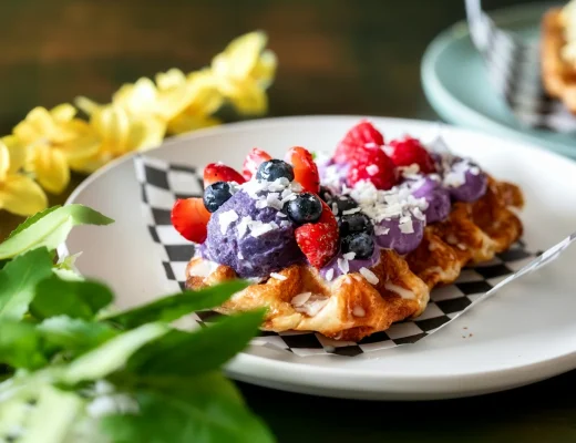Croissant mit violetter Creme, frischen Beeren und Kokosraspeln als Symbolbild für den Ube-Food-Trend